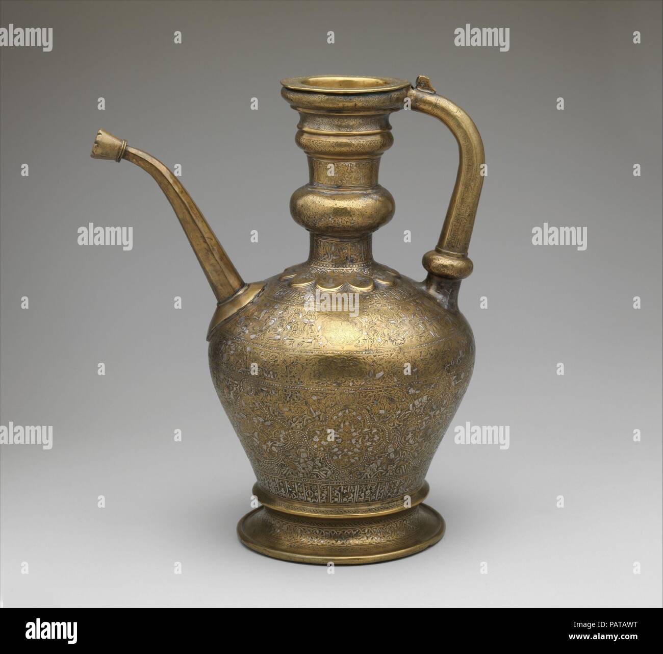 Ewer with Inscription, Horsemen, and Vegetal Decoration. Dimensions: H. 14 1/2 in. (36.8 cm)  W. 12 1/16 in. (30.6 cm)  Diam. 8 3/8 in. (21.3 cm). Maker: `Umar ibn al-Hajji Jaldak. Date: dated A.H. 623/ A.D. 1226.  This lavishly decorated object is inscribed around the neck: 'Made by 'Umar ibn al-Hajji Jaldak, the apprentice of Ahmad al-Dhaki al-Naqqash al-Mawsili in the year 623 [1226 A.D.].' Ahmad al-Mawsili, originally from Mosul in Upper Mesopotamia, was a famous metalworker who had a number of pupils. Museum: Metropolitan Museum of Art, New York, USA. Stock Photo